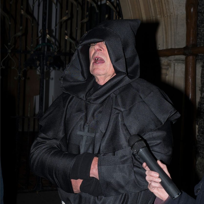 An actor, dressed as a black monk for a ghost walk