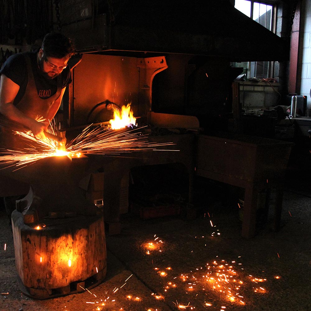 Black smith at work, hammering metal work