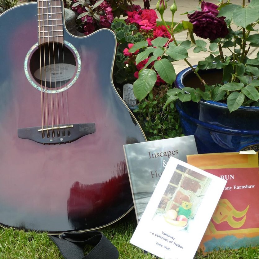 Acoustic guitar and poetry books