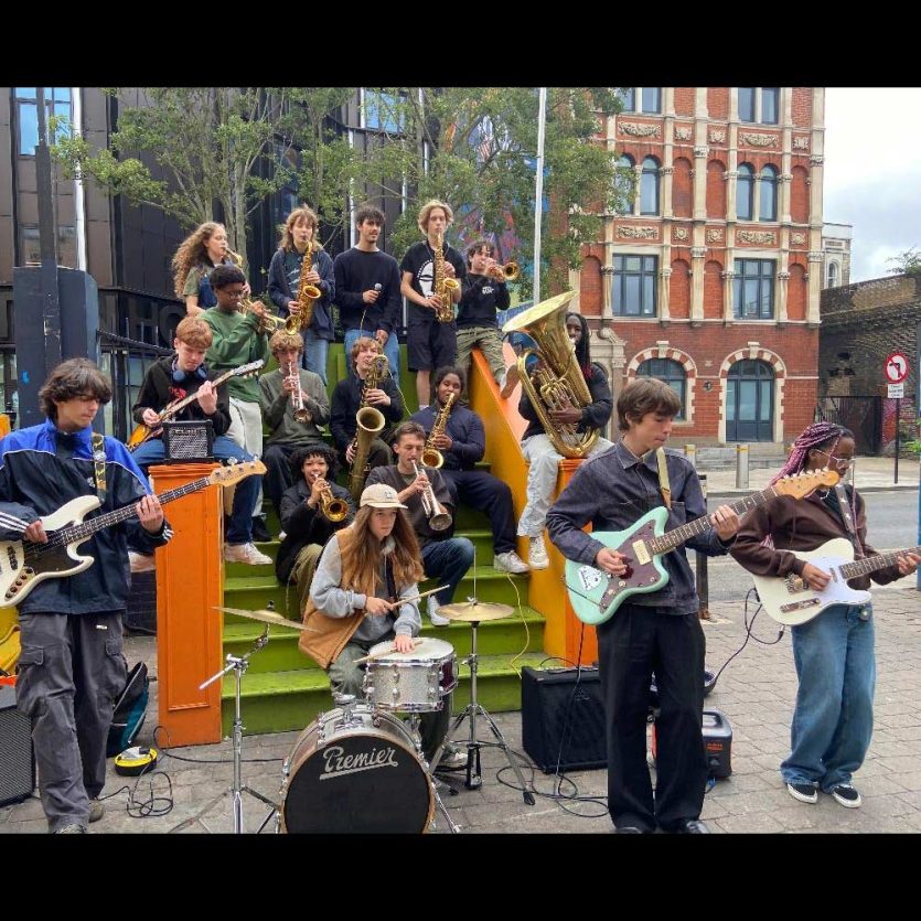 Youthsayers band members playing a live gig outdoors